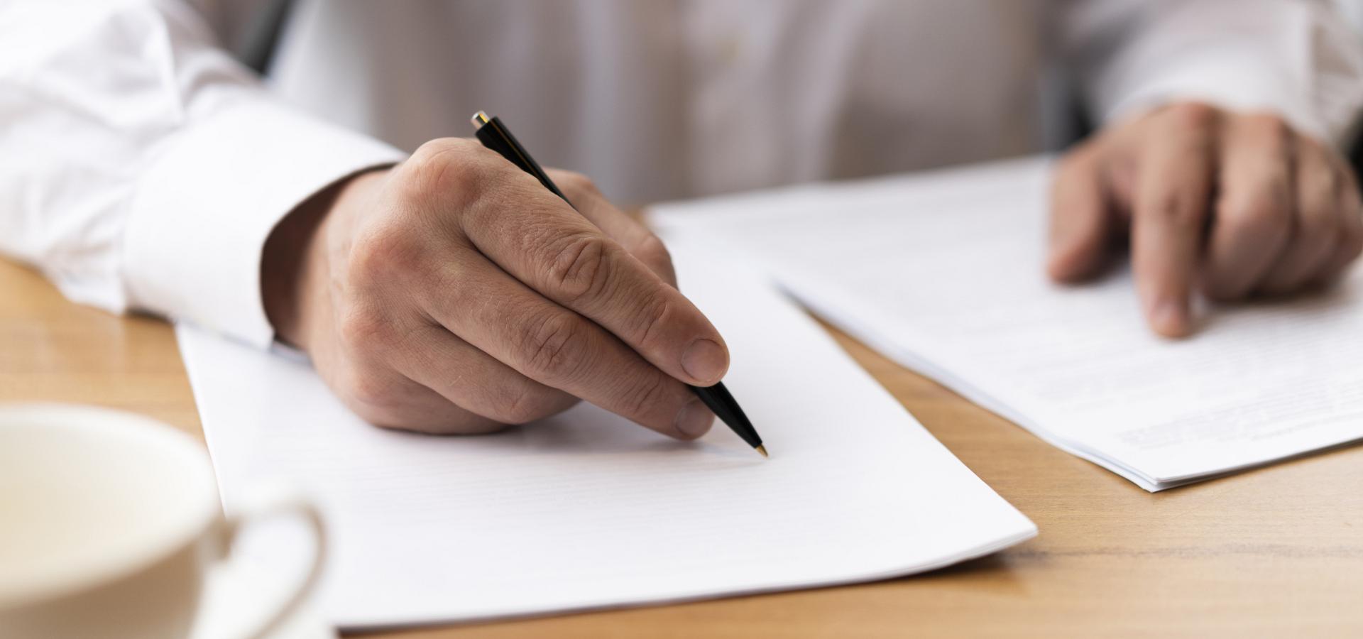 businessman signing papers office(1)